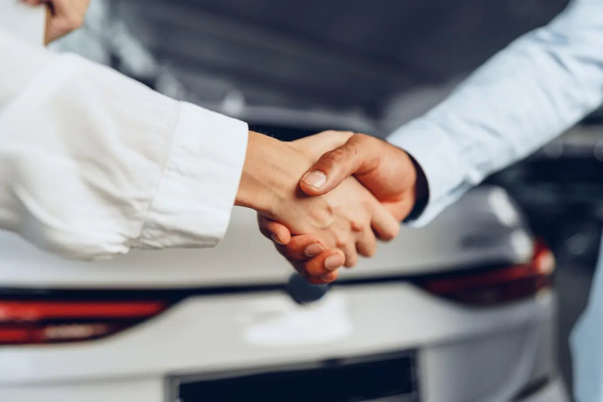 Closeup shakehand of car seller and buyer.